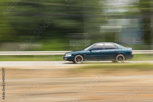 Green Car panning speed on road, Thailand asia © prwstd