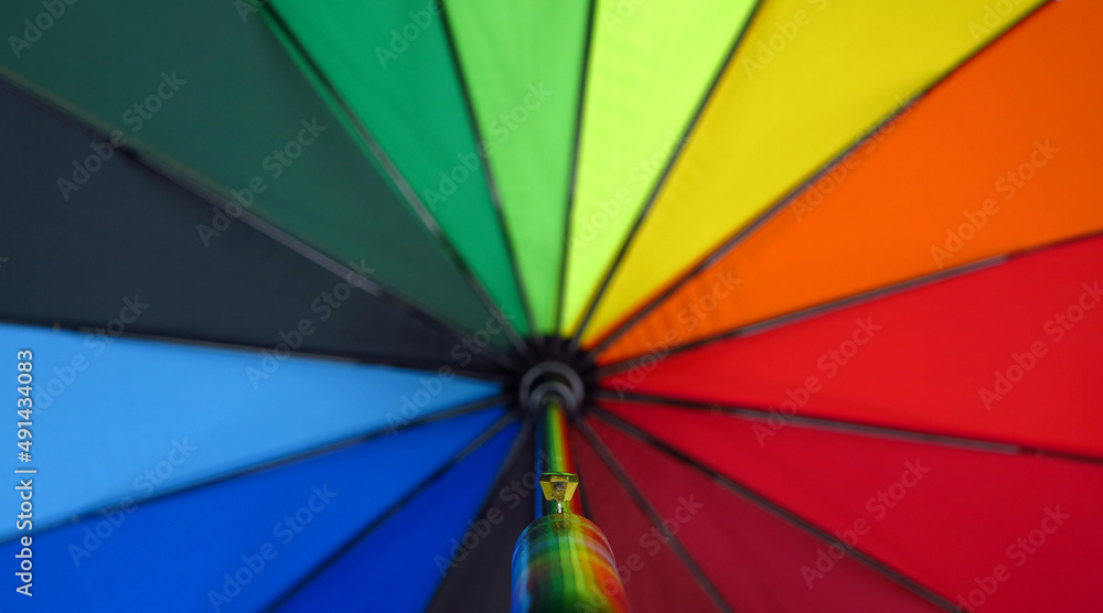 close up handle of multicolored umbrella close up handle of multicolored umbrella