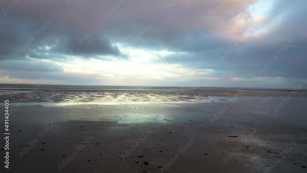 aerial drone view texel wadden island mudflats approaching dusk, fpv drone and birds flying over land, slufter vallei in the Netherlands aerial drone view texel wadden island mudflats approaching dusk, fpv drone and birds flying over land, slufter vallei in the Netherlands