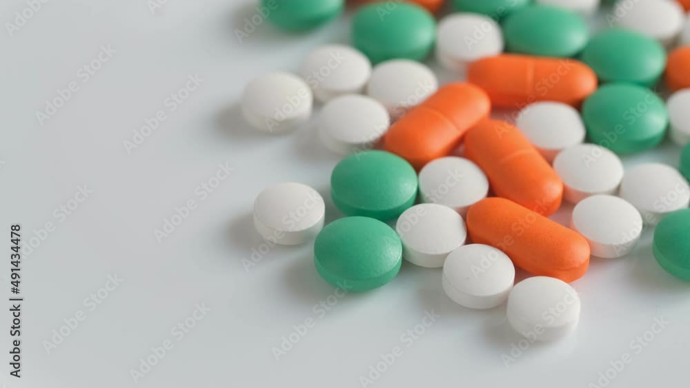 Slow Motion Shot of rotation Colorful Pills on wite Background. 4K Slow Motion Shot of rotation Colorful Pills on wite Background. 4K