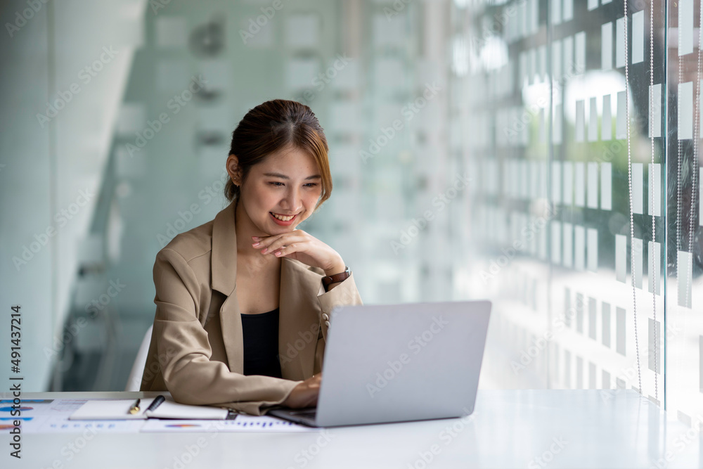 Beautiful Asian business woman working at the office with laptop. Beautiful Asian business woman working at the office with laptop.