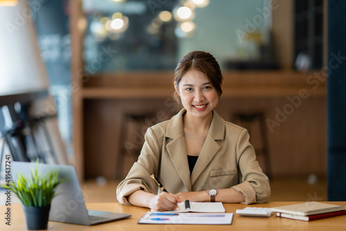 Portrait of a business woman smiling and looking at the camera.