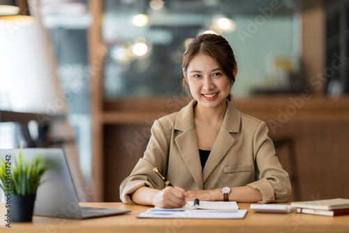 Portrait of a business woman smiling and looking at the camera.