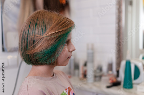 Teenage girl with colored green hair in a bob hairstyle