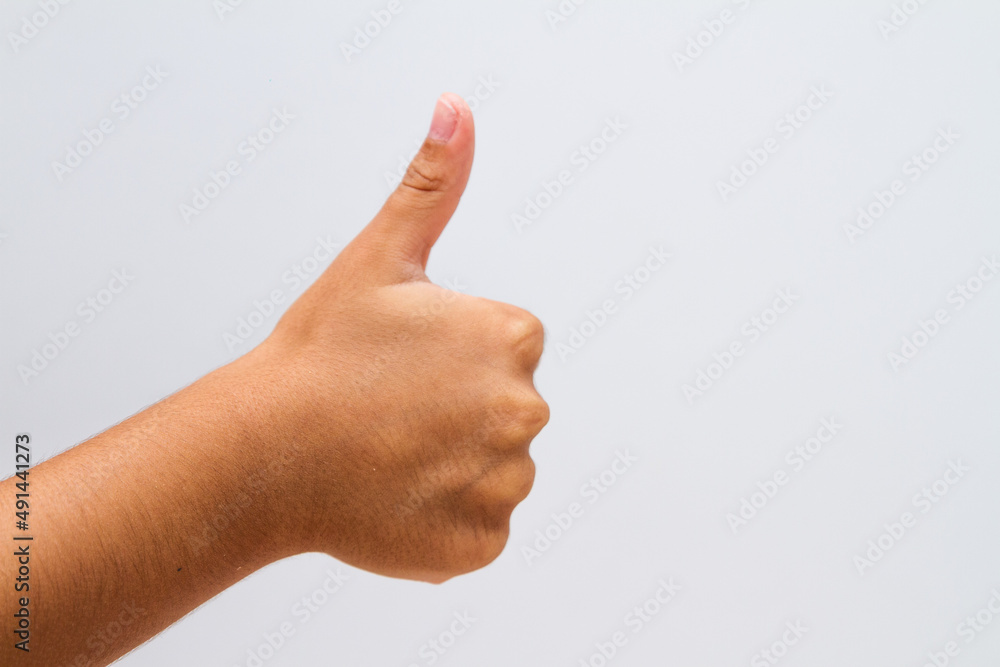 child making a like sign on a white background. child making a like sign on a white background.