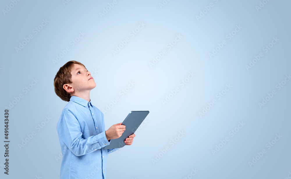 Handsome boy wearing formal shirt is holding tablet device Handsome boy wearing formal shirt is holding tablet device