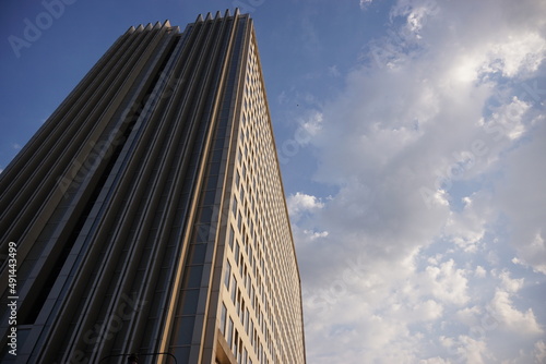 high rise apartment building against the sky against a bright blue sky background