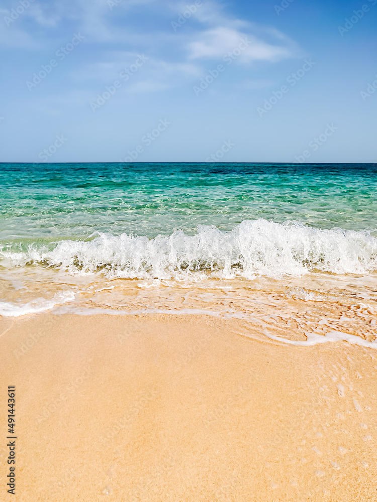 Sea shore sand beach landscape with blue sky background on sun summer day. Ocean vacation concept. Digital detox, isolation on tropical island. White sailboat on wave. Calm, tranquil state of mind.