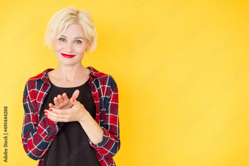 Supportive applause. Happy woman. Good job. Positive smiling middle-aged lady clapping hands expressing joy isolated yellow copy space. Supportive applause. Happy woman. Good job. Positive smiling middle-aged lady clapping hands expressing joy isolated yellow copy space.