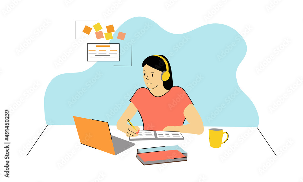 a young dark-skinned girl - a student with black hair, in yellow headphones on a blue background, sits at her desk in front of a laptop with a cup, makes notes in a notebook. Study Online