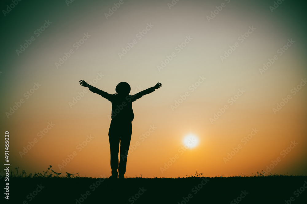 Silhouette of the woman standing lonely at the river during beautiful sunset Silhouette of the woman standing lonely at the river during beautiful sunset