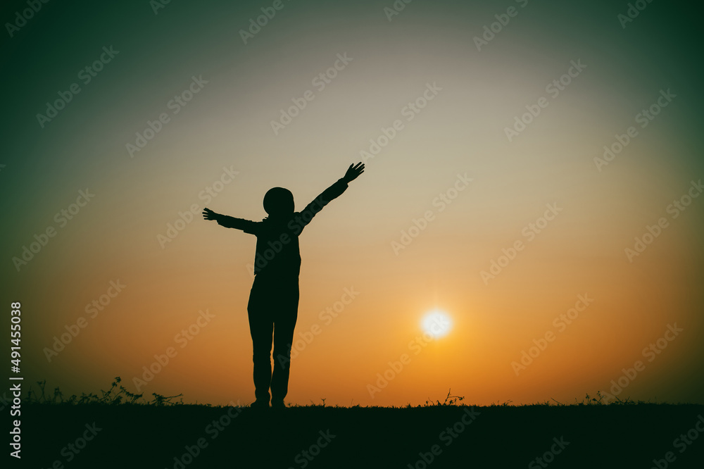 Silhouette of the woman standing lonely at the river during beautiful sunset Silhouette of the woman standing lonely at the river during beautiful sunset