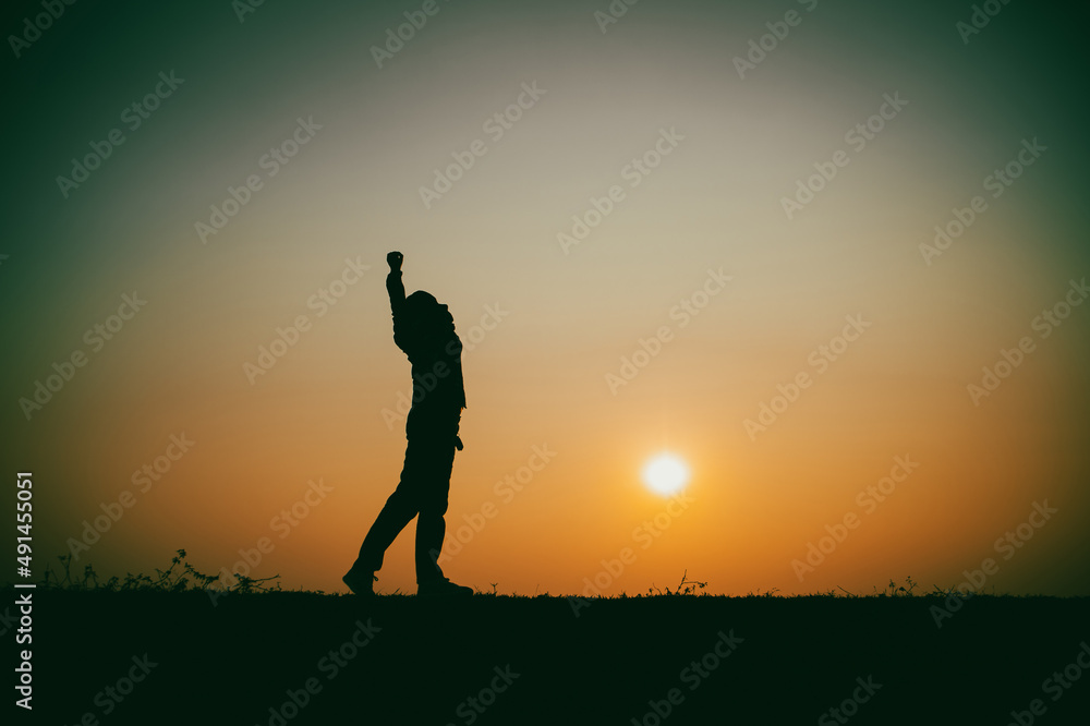 Silhouette of the woman standing lonely at the river during beautiful sunset Silhouette of the woman standing lonely at the river during beautiful sunset