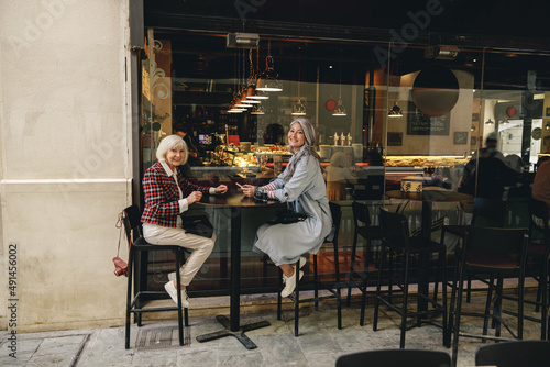 Urban female friends enjoying conversation in cafe