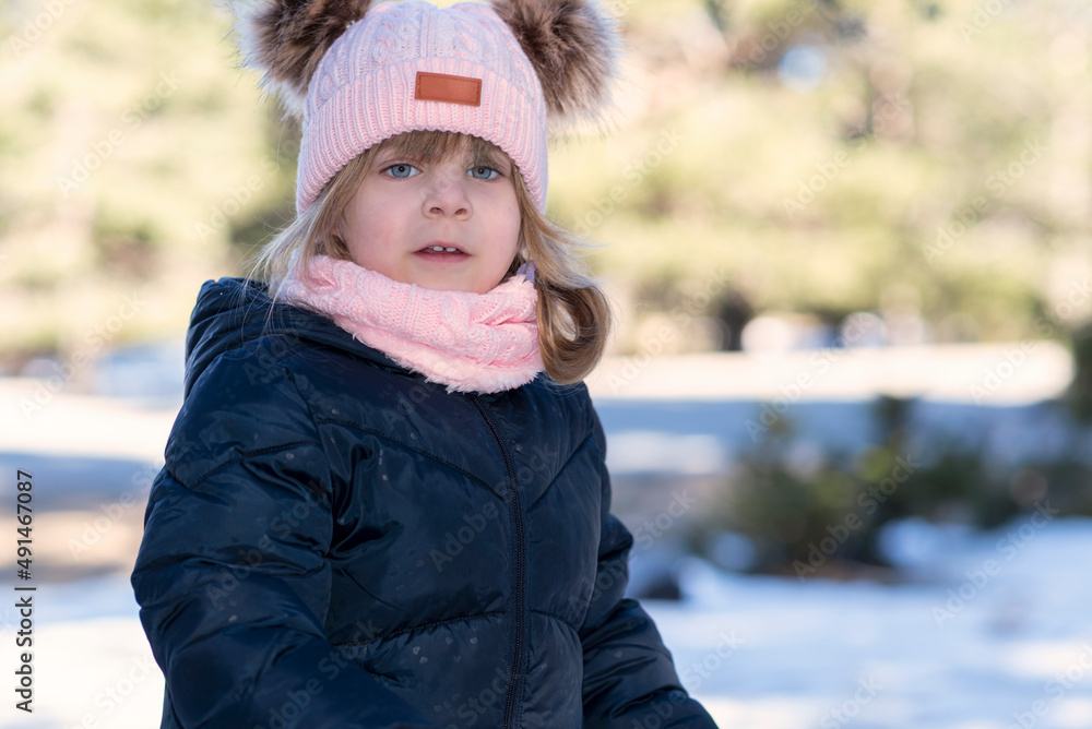 Portrait of a Caucasian girl, wearing a winter hat. Portrait of a Caucasian girl, wearing a winter hat.