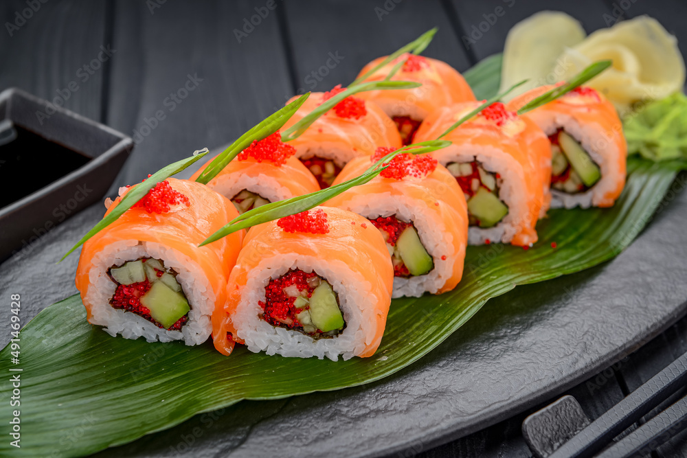 Sushi California rolls with salmon and red tobiko caviar Sushi California rolls with salmon and red tobiko caviar