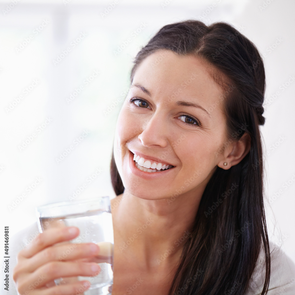 You should drink at least 8 glasses per day. Cropped portrait of an attractive young woman drinking a glass of water. You should drink at least 8 glasses per day. Cropped portrait of an attractive young woman drinking a glass of water.