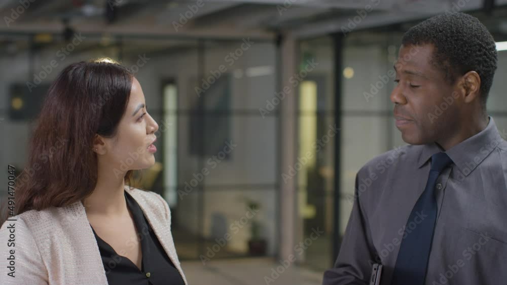 Mid Shot of Man Approaching Female Colleague Mid Shot of Man Approaching Female Colleague