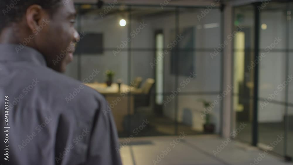 Mid Shot of Man on Phone then Talking to Colleague Mid Shot of Man on Phone then Talking to Colleague