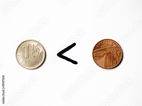 One ruble worth less than one penny. Rouble coin, penny coin. Сurrency exchange. Economic crisis in Russia. War in Ukraine. Fall of russian currency. Business and finance. Economic sanctions effect