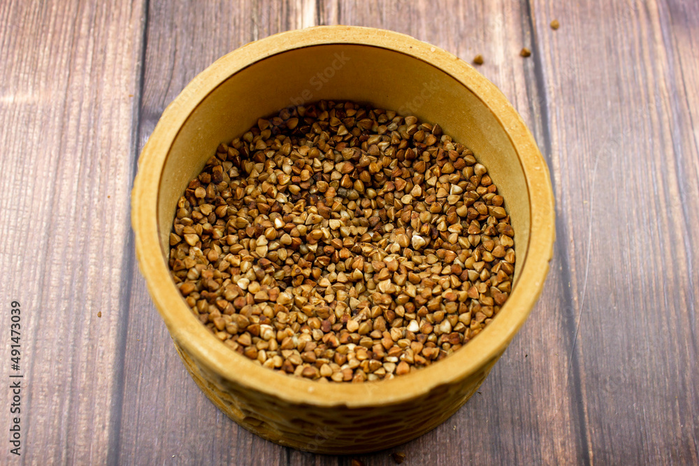 Buckwheat natural. A grain of buckwheat. Buckwheat in a wooden jar. Buckwheat and palms. Buckwheat natural. A grain of buckwheat. Buckwheat in a wooden jar. Buckwheat and palms.