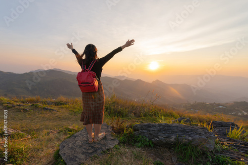 Portrait of Asian woman, a tourist, travel on green mountain hills with fog on holiday vacation. Nature landscape background, Thailand. People lifestyle.