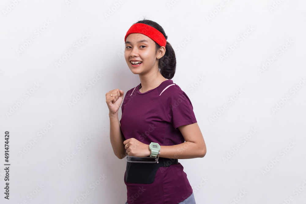 Fototapeta premium young beautiful asian sporty woman running on white background 