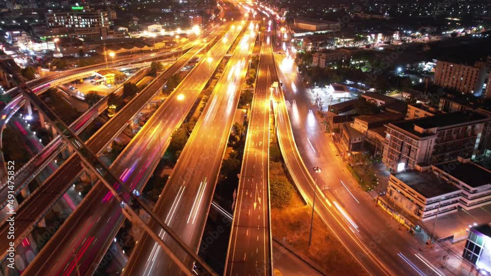 Top view of car traffic transport on crossing multiple lanes highway or expressway in Asia city at night. Civil engineering, technology background, Asian transportation concept. Top view of car traffic transport on crossing multiple lanes highway or expressway in Asia city at night. Civil engineering, technology background, Asian transportation concept.