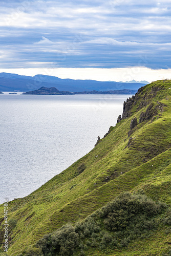 A view towards the Scottish mainland from Lealt Falls on the north east coast of the Isle of Skye, Highland, Scotland UK. The Isle of Rona is in the foreground. © Stephen