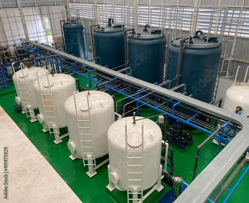 Konstfotografi top view of indoor watertreatment plant It has a blue fiberglass water tank and a white steel filter tank system