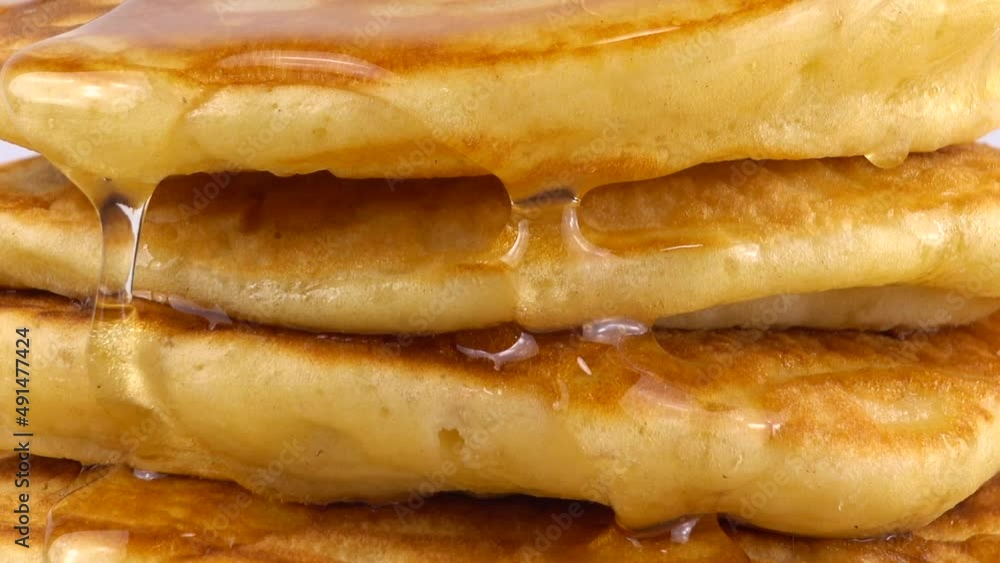 Pancakes with honey on a white background. Pancakes with honey on a white background.
