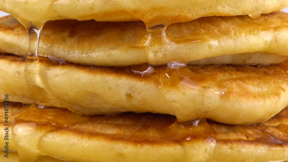 Pancakes with honey on a white background. Pancakes with honey on a white background.