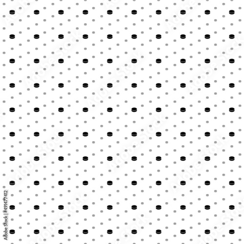 Square seamless background pattern from geometric shapes are different sizes and opacity. The pattern is evenly filled with small black hockey pucks. Vector illustration on white background