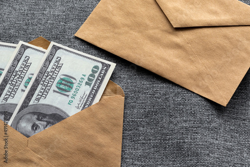 Offering a bribe with American hundred-dollar bills in an envelope. Corruption and refusal to bribe American banknotes.