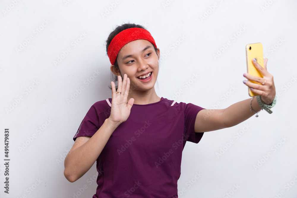 young asian sporty woman using mobile phone on white background
young asian sporty woman using mobile phone on white background