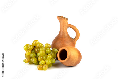 Georgian traditional clay vessel kvevri (qvevri ), jug(doqi)  for wine and grapes on white isolated background. photo