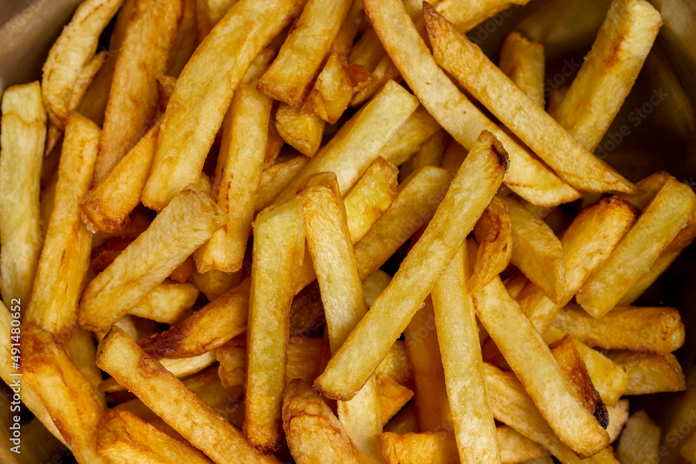 Crispy French fries background closes up image. Crispy French fries background closes up image.