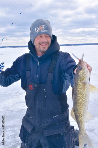 Angler with a walleye caught through the ice  photo