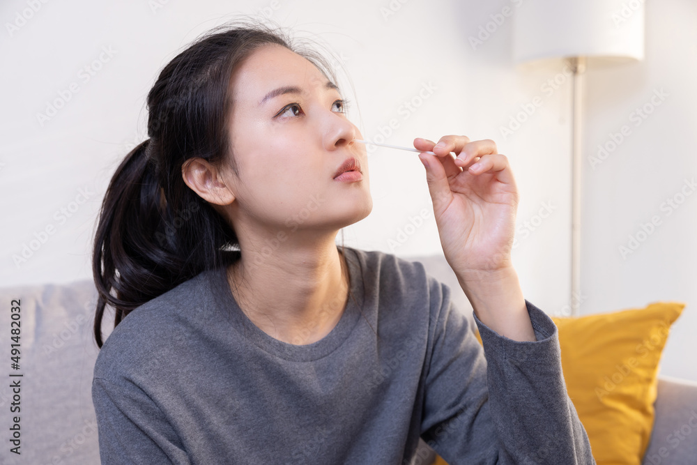 Woman Using Rapid Antigen Test Kit (ATK) for Covid-19 Virus Self Test at Home Woman Using Rapid Antigen Test Kit (ATK) for Covid-19 Virus Self Test at Home