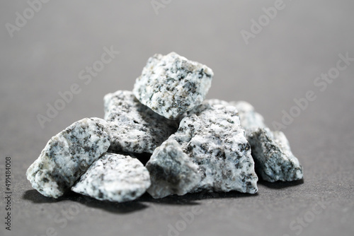 Granites are coarsely crystalline plutonic rocks rich in quartz and feldspar, but also contain dark minerals, mainly mica, photographed in the studio