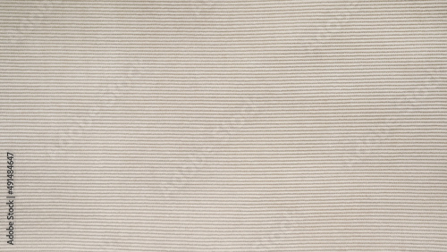 horizontal textile background - beige corduroy jacket close up photo