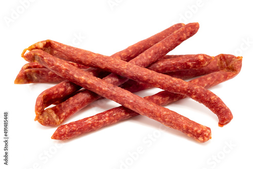 Dry sausage on a white background. Thin smoked sausages isolated