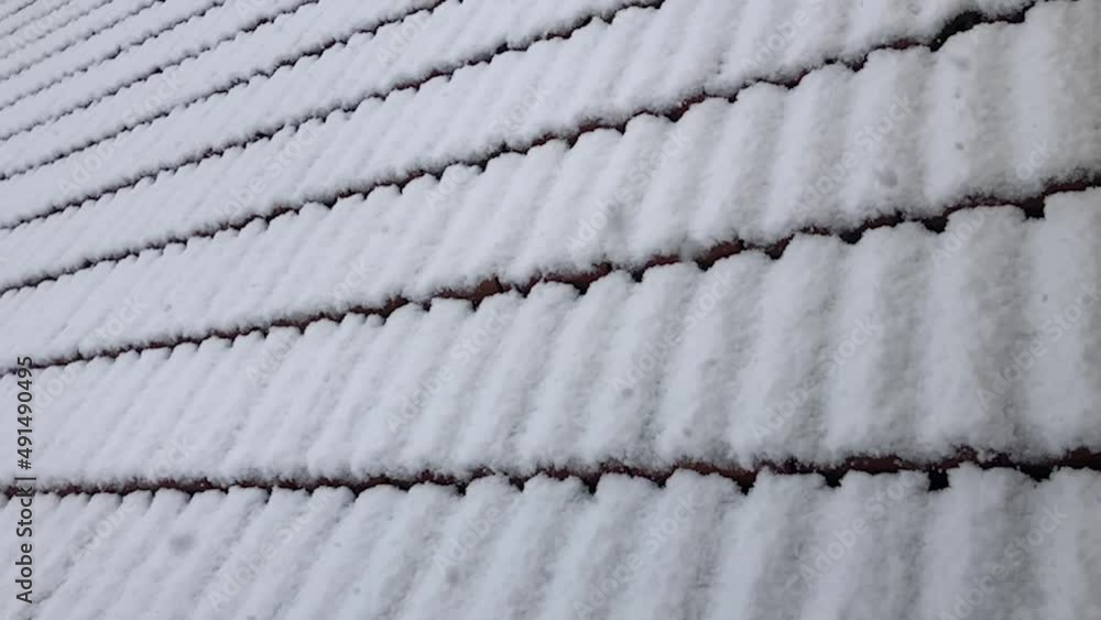 snowflakes falling on roof tiles and nature of winter season snowflakes falling on roof tiles and nature of winter season