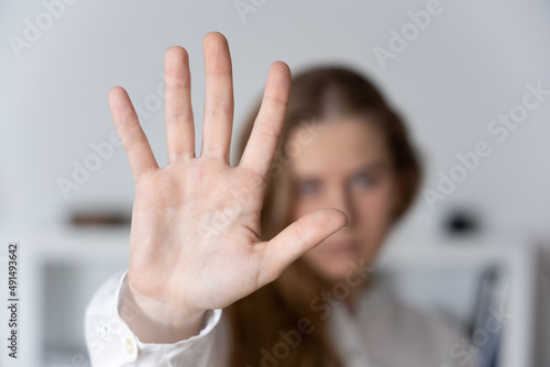Woman making stop sign with hand. Domestic and sexual violence concept