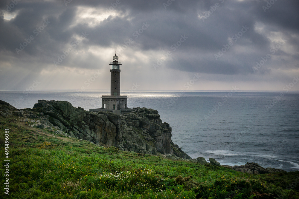 LIGHTHOUSE ON THE COAST OF GALICIA ON A CLOUDY DAY