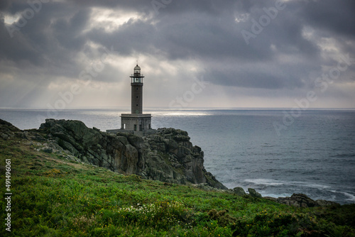 LIGHTHOUSE ON THE COAST OF GALICIA ON A CLOUDY DAY