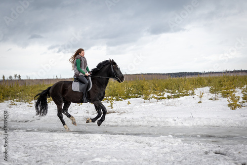 girl rides a horse. Walk with a horse through the countryside.