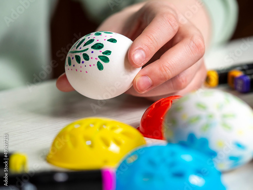 Painted egg in hand. Concept of preparation for Easter.