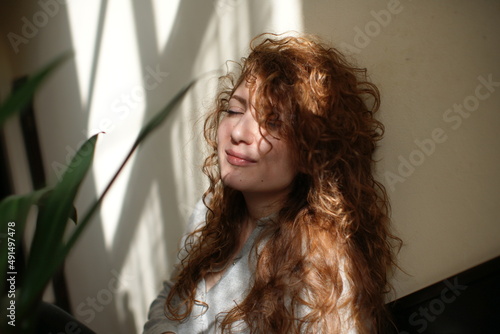 portrait of a woman. Lights and shaddows. Mood. Curly hair  photo