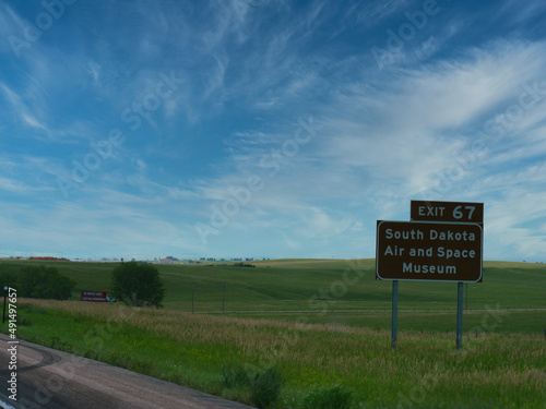 Roadside sign with directions to South Dakota Air and Space Museum along US Highway 90.